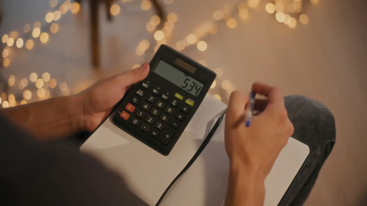 Man calculating budget sitting at home