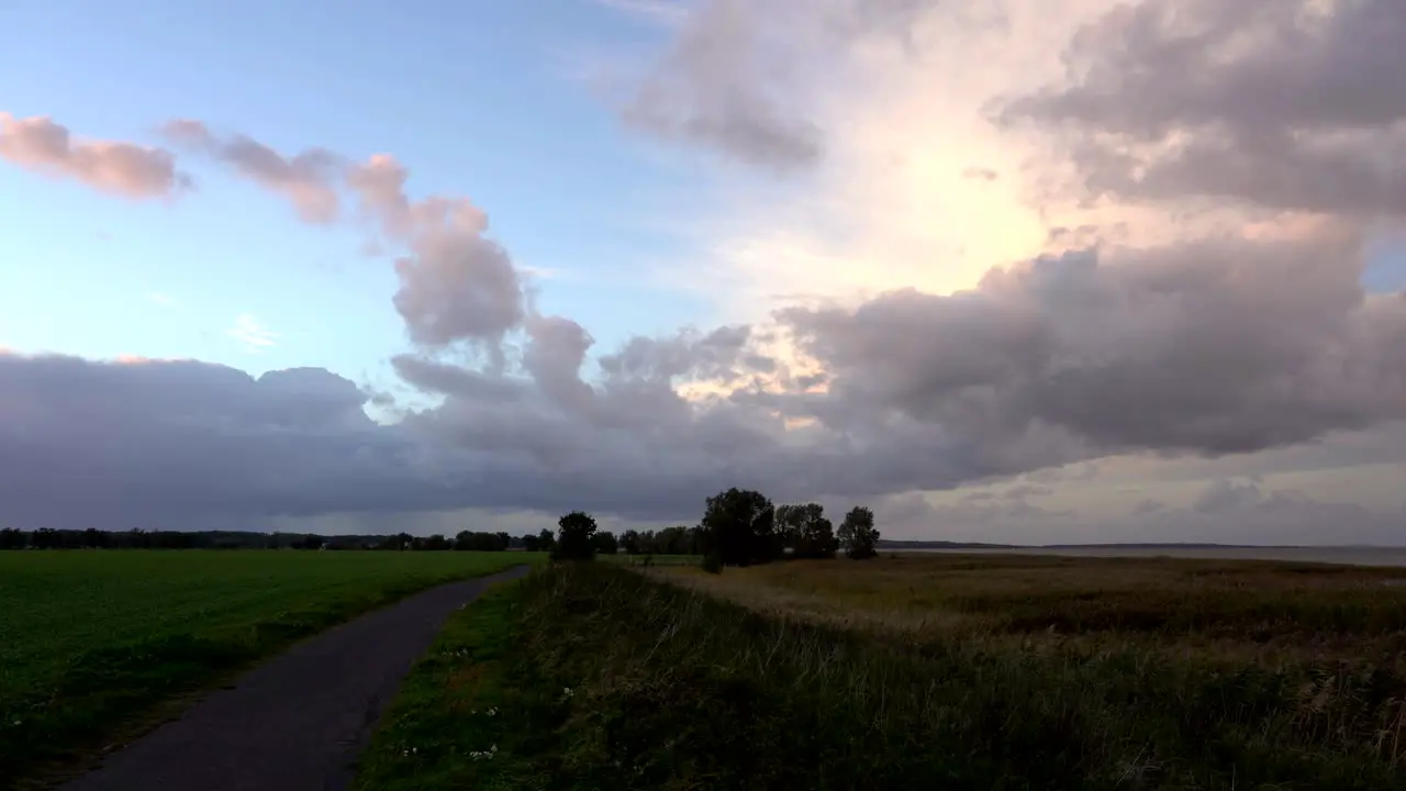 lonely sidewalk in nature with impressive clouds moving over the scene