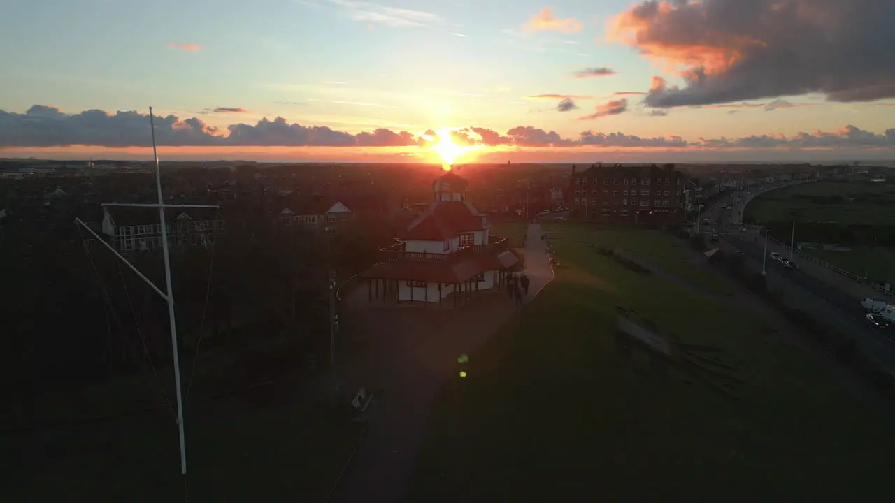 Sunset behind old building on hill with rise up over urban area of Fleetwood UK