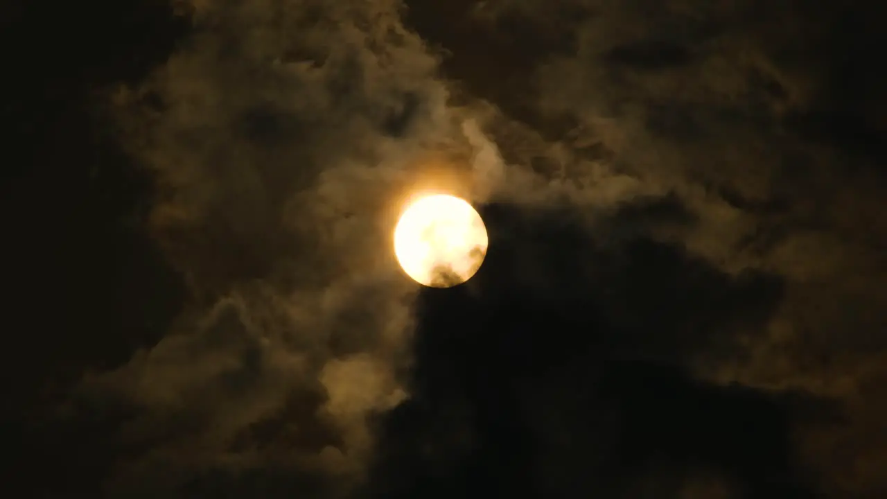 Sunset with dark clouds moving in front of the sun