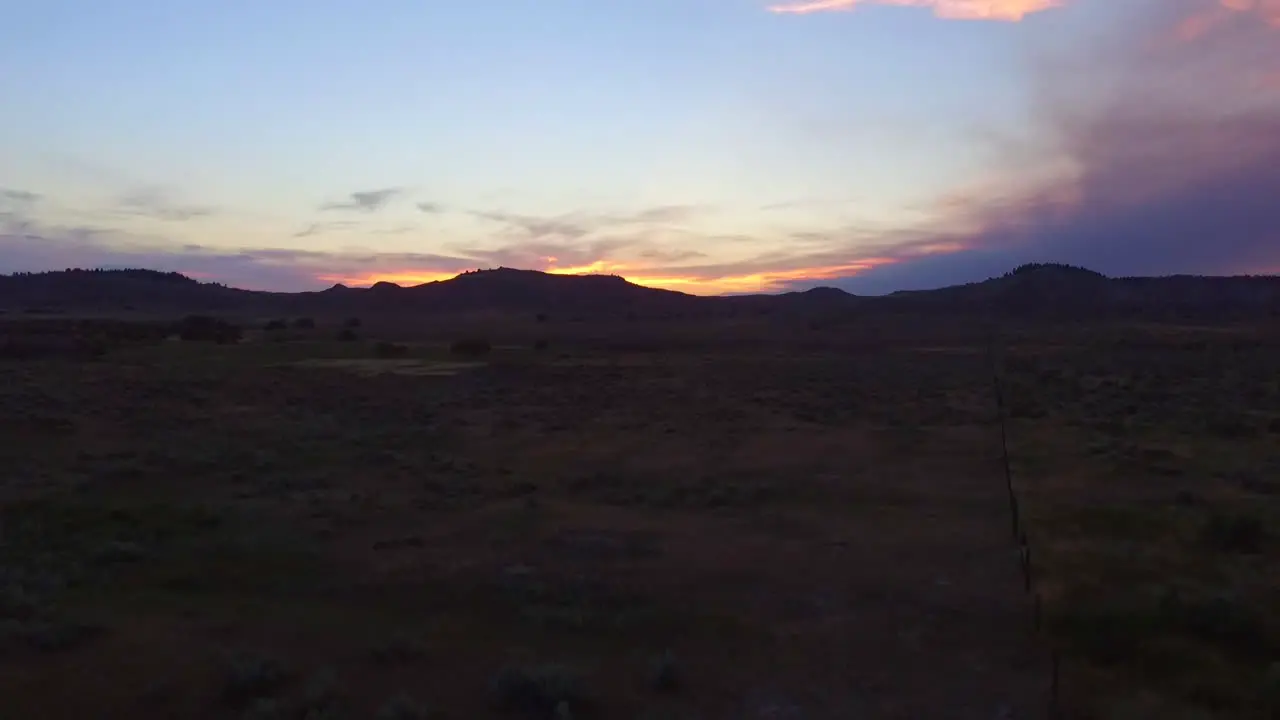 A Cinematic Drone Shot Flying over a Field at Sunset