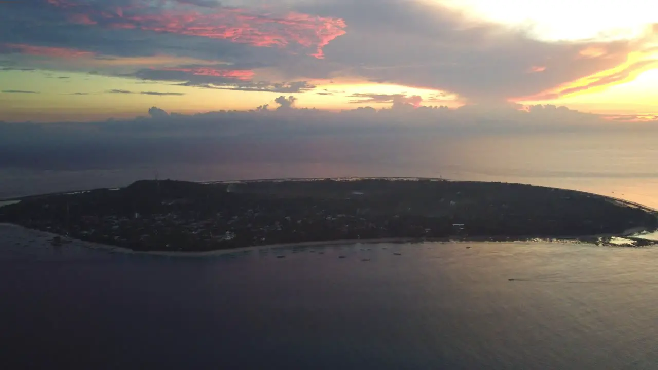 Aerial view of gili trawangan island in the middle of the ocean during sunset cloudy sky Indonesia beautiful paradise hotel resort holiday destination