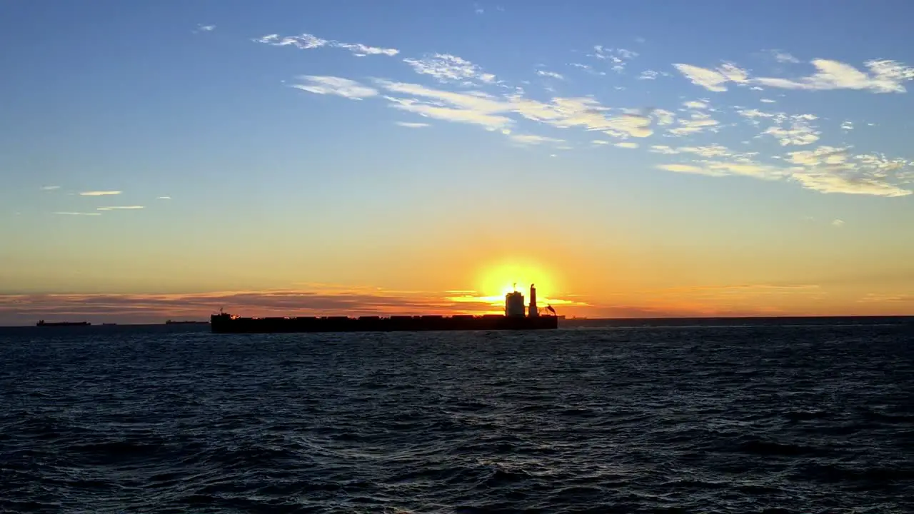 A static shot of Cargo ship on sea in the rays of sun