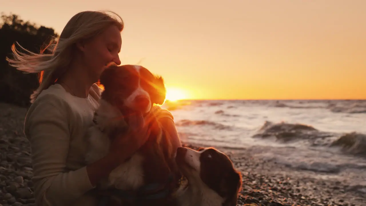 Woman With Two Beloved Dogs Resting By The Lake