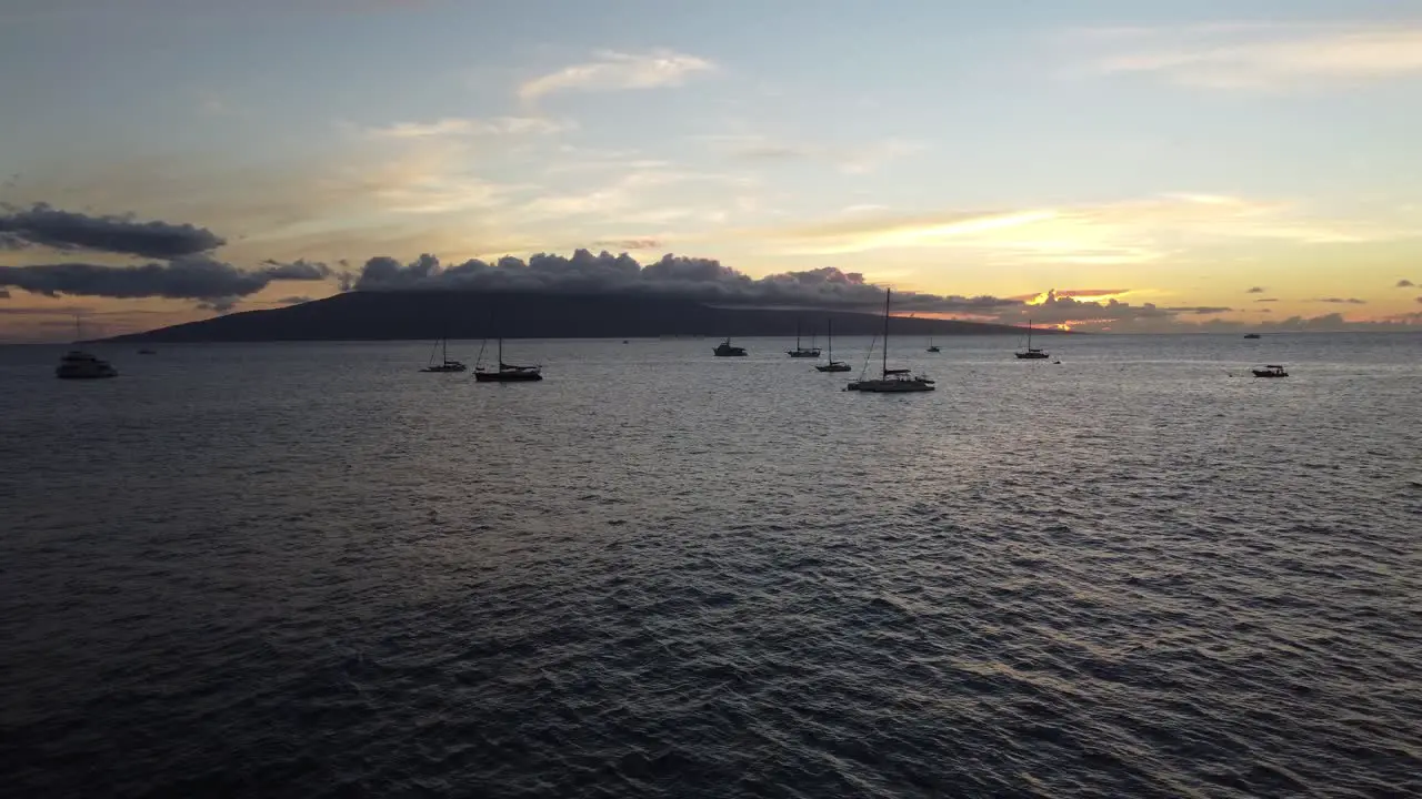 Cinematic sunset shot at the coast of Maui with island in the background