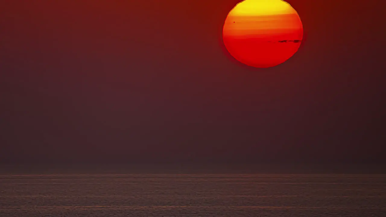 Timelapse shot of beautiful red sunrise over the sea during morning time