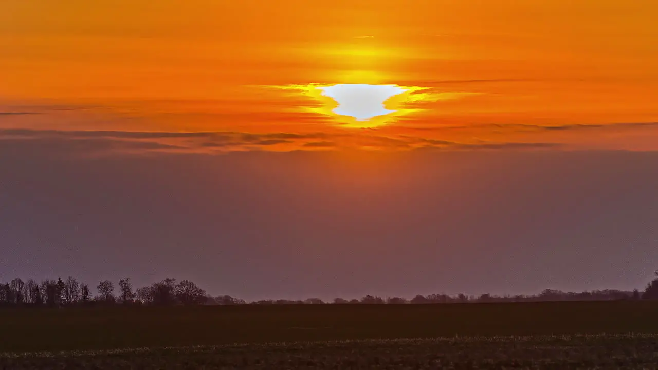 Cinematic orange sunrise from behind the clouds