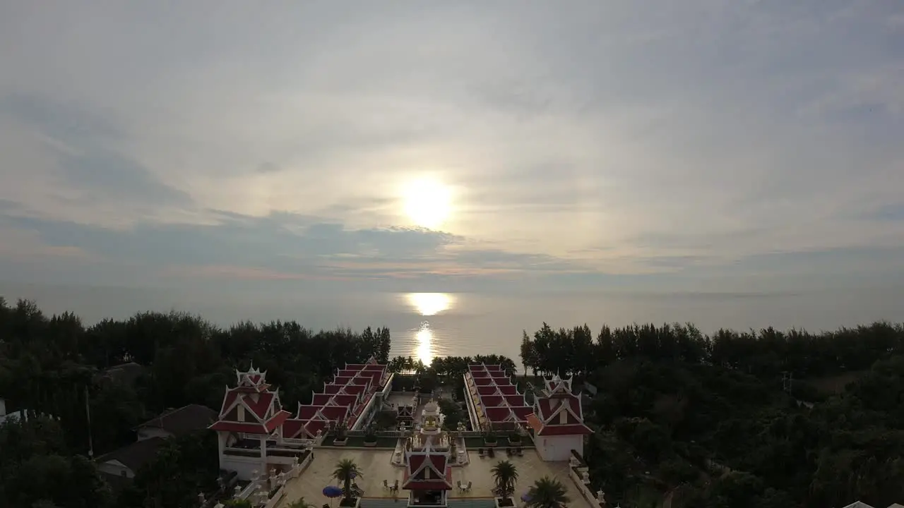 Aerial time lapse of a dramatic golden sunrise overlooking a hotel resort and ocean view of the Gulf of Thailand in Cha-Am Beach Thailand