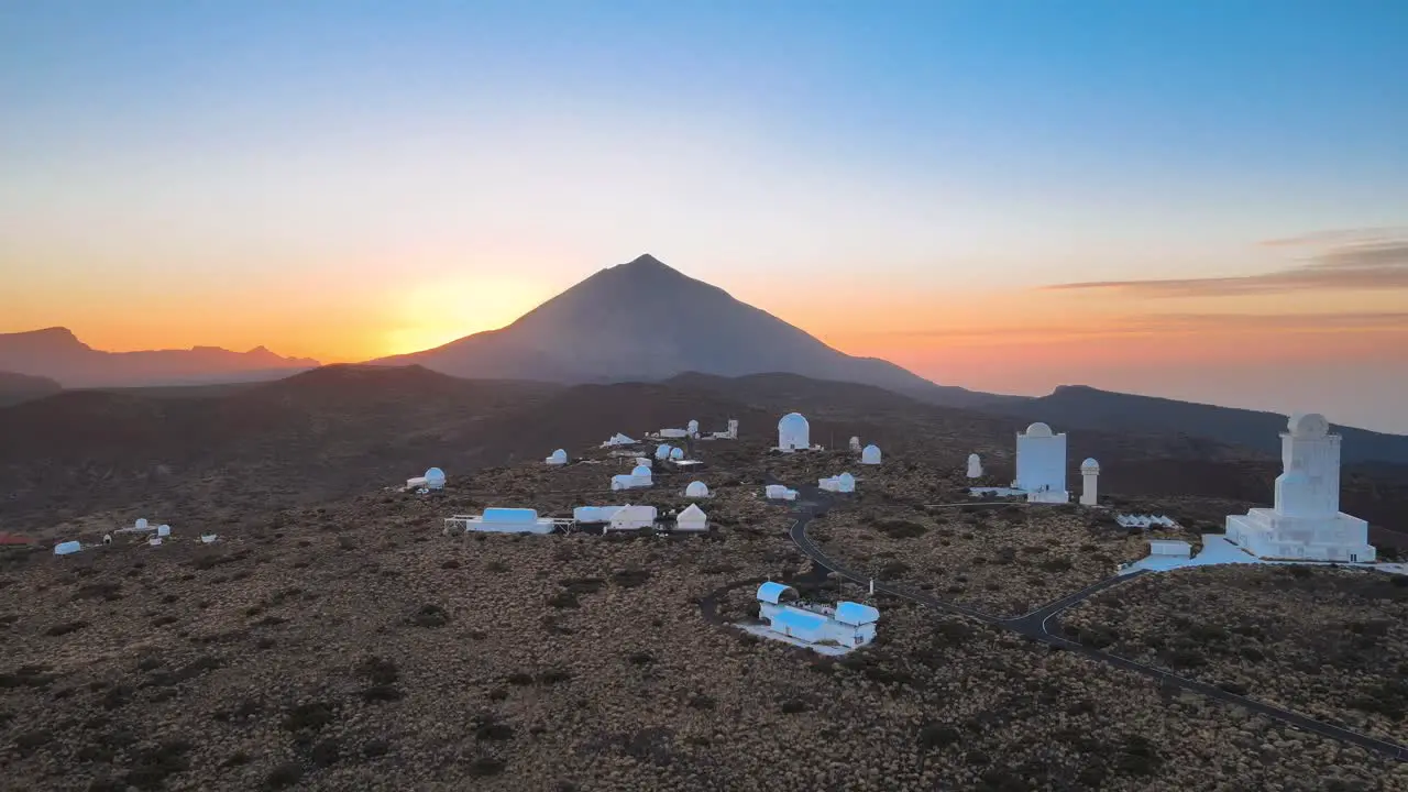 Breathtaking Aerial View of Large Mountain Silhouette Against Blue and Orange Sky Tenerife Spain