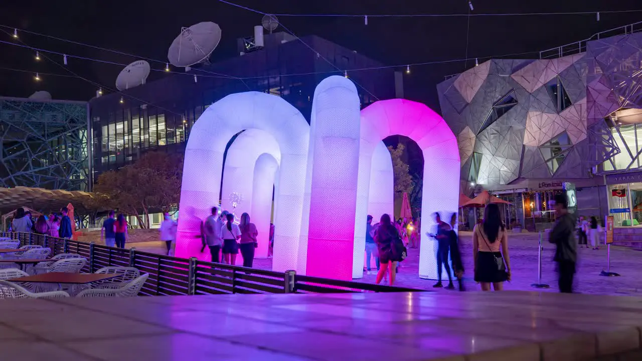 Wide Shot Time Lapse of Sky Castle Inflatable Interactive LED Light rainbow arches by ENESS during Christmas 2020 at Federation Square Melbourne Victoria Australia