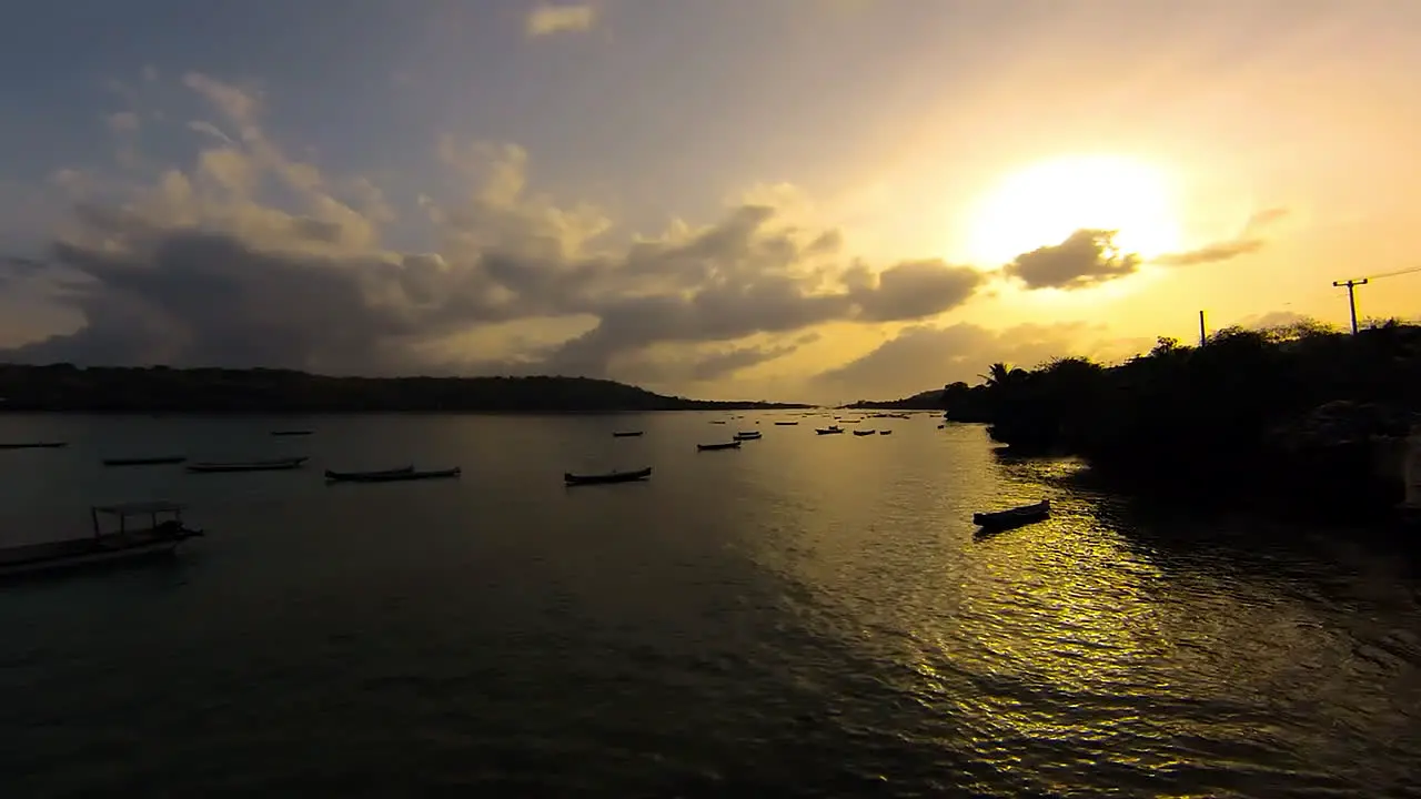 TimeLapse Sunrise over Ceningan Island  boats bobbing around in ocean straight