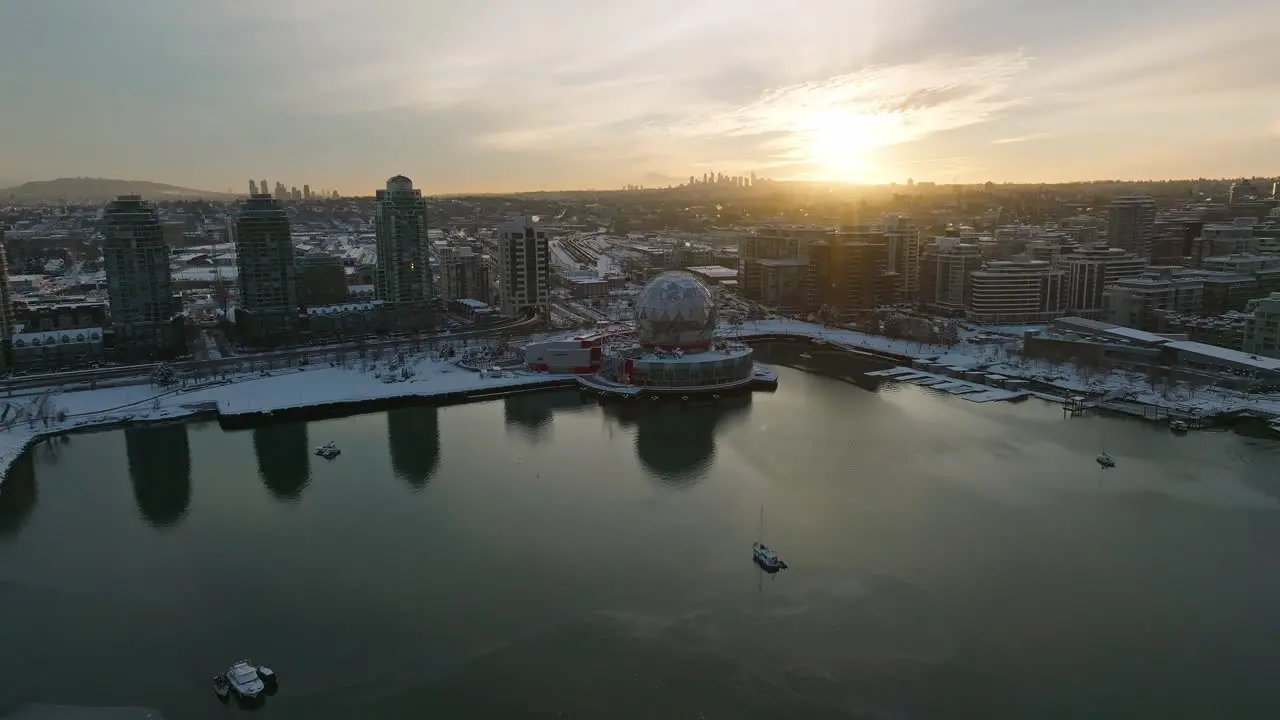 Vancouver Globe Science World building covered in winter snow Drone Aerial Sunset Shot