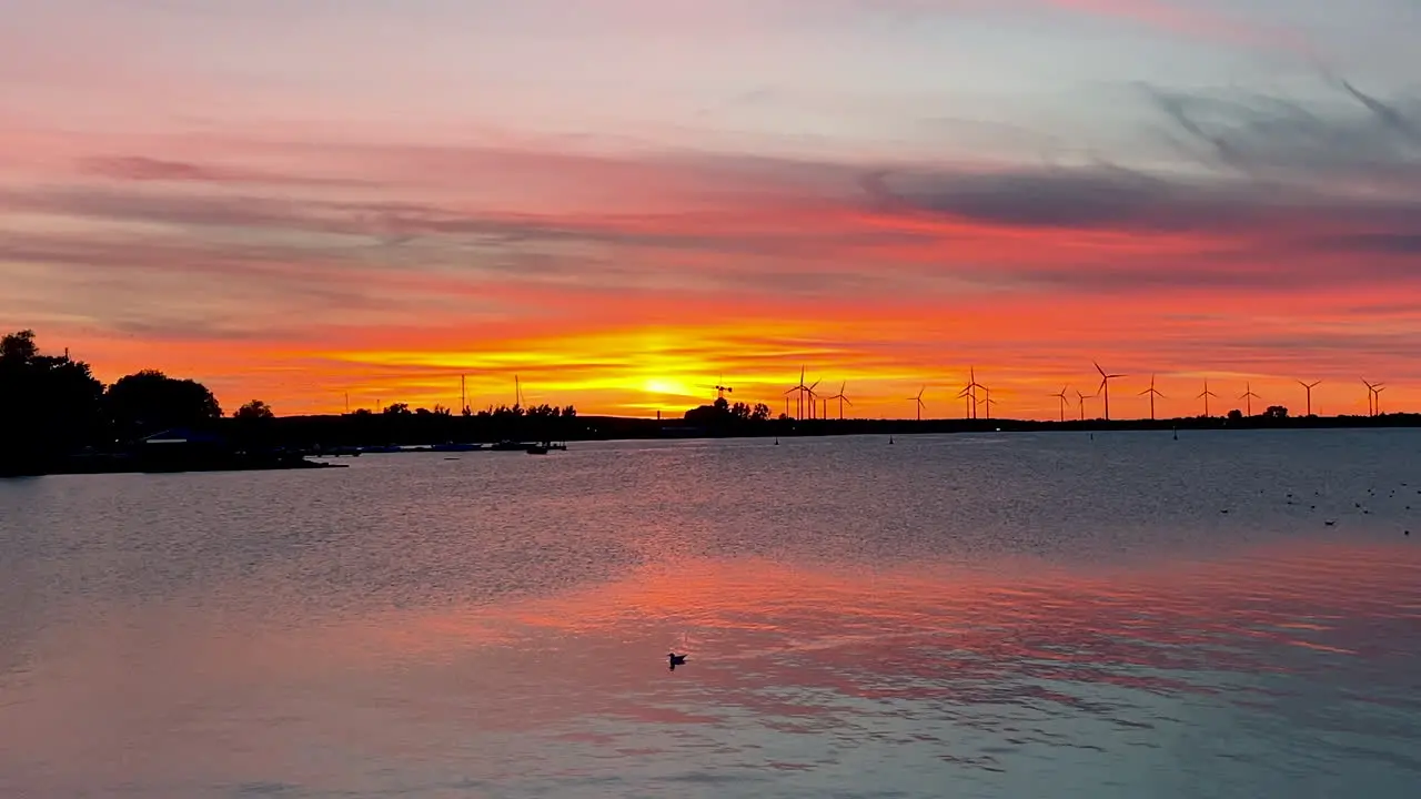 Stunning sunset over the Baltic Sea in Puck Poland with windmills in background