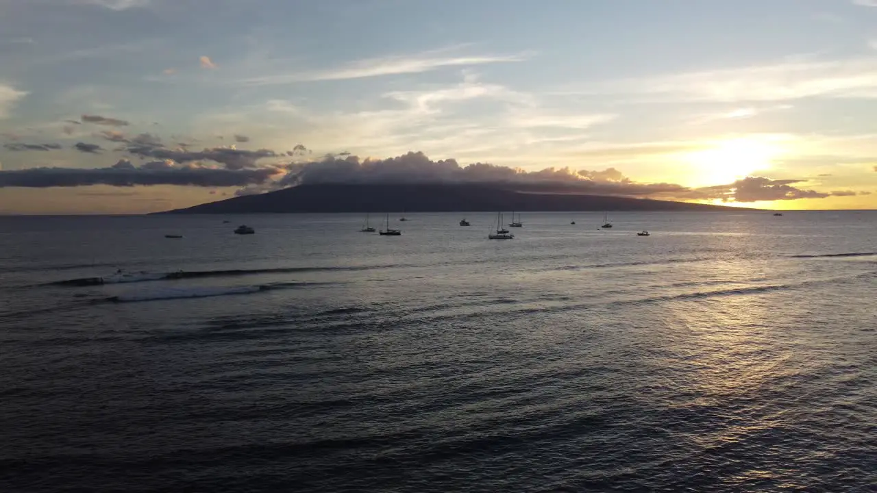 Beautiful cinematic sunset shot with boats and Hawaiian islands in the background