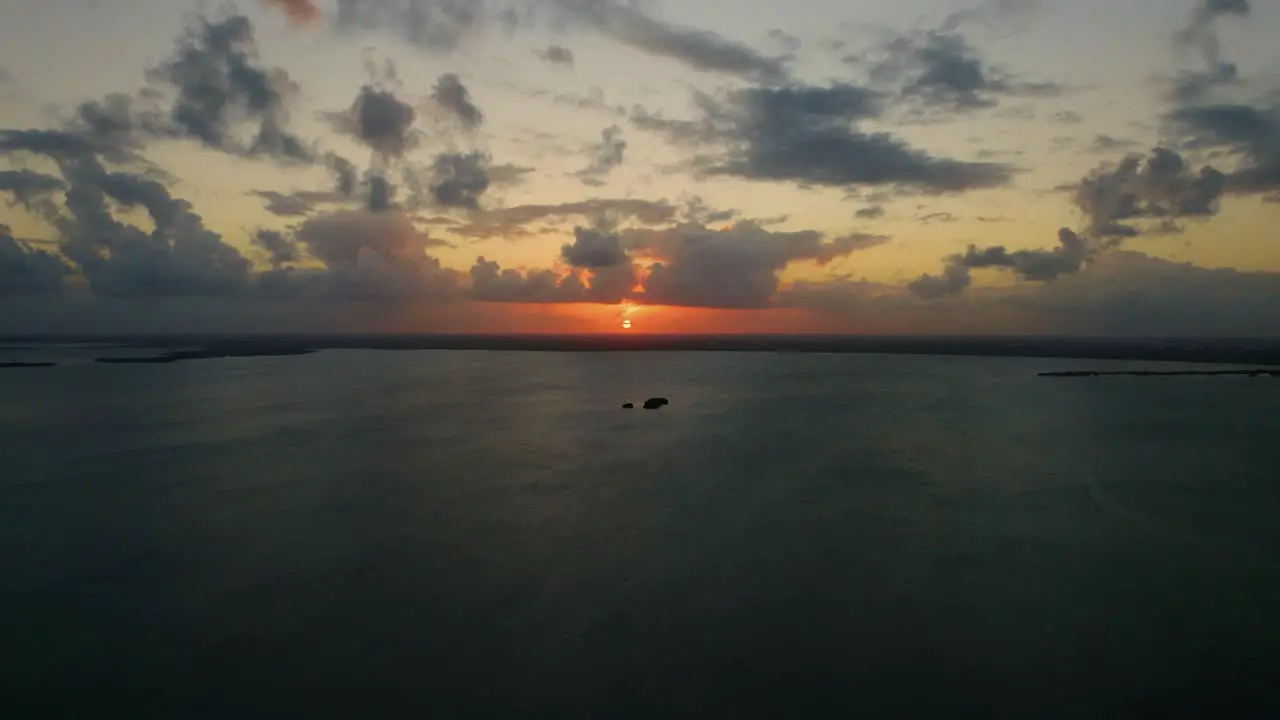 Approach of Small Single Island Surrounded by Water Dusk Evening Aerial