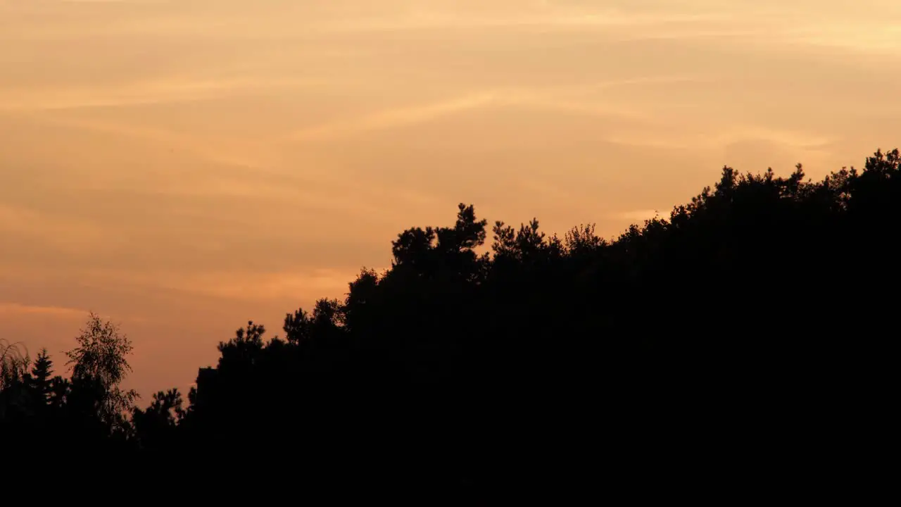 Amazing Time-Lapse Of Evening Or Morning Sky With Orange And Yellow Clouds and plane flying by