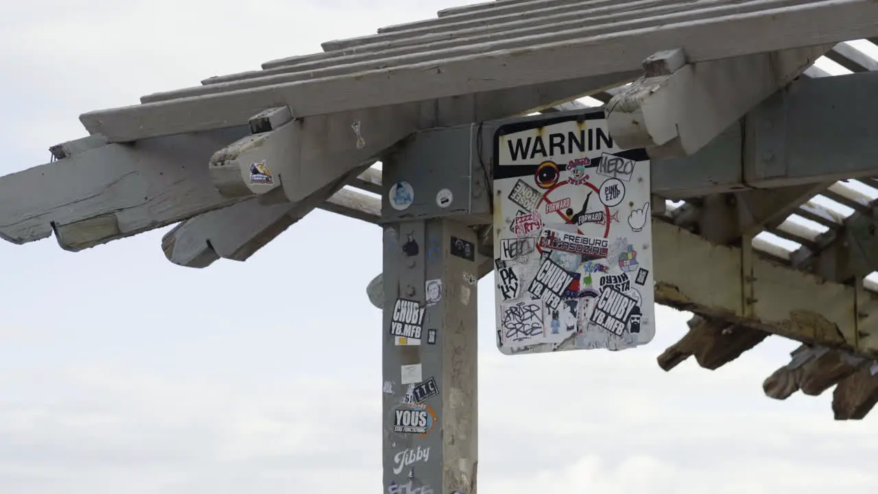 Quirky artistic modern design of warning sign hanging at Hawaiin beach