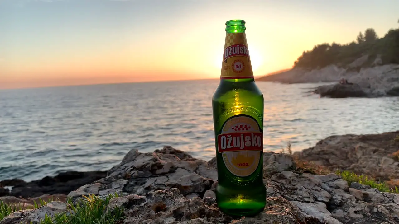 Croatian beer Ožujsko in front of the beautiful sunset on the Adriatic Croatia