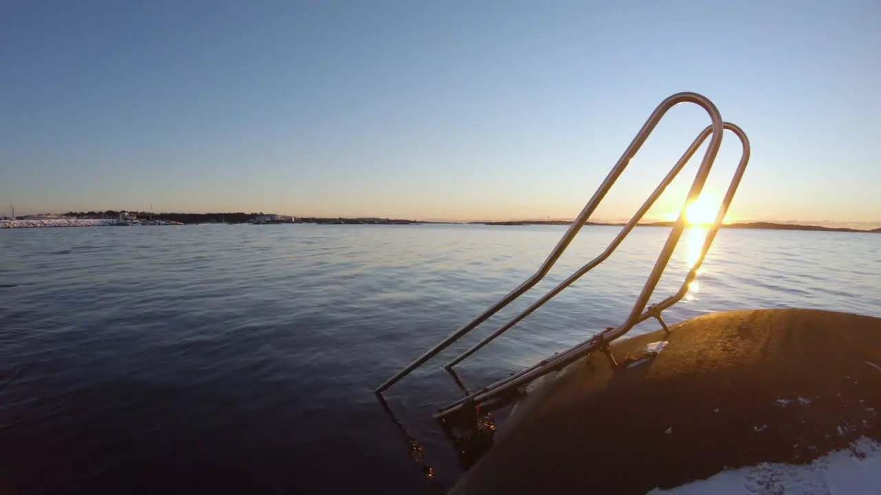 4k Close-up of metal stairs for cold bathing at the shore of Gothenburg Sweden on a cold winter sunset