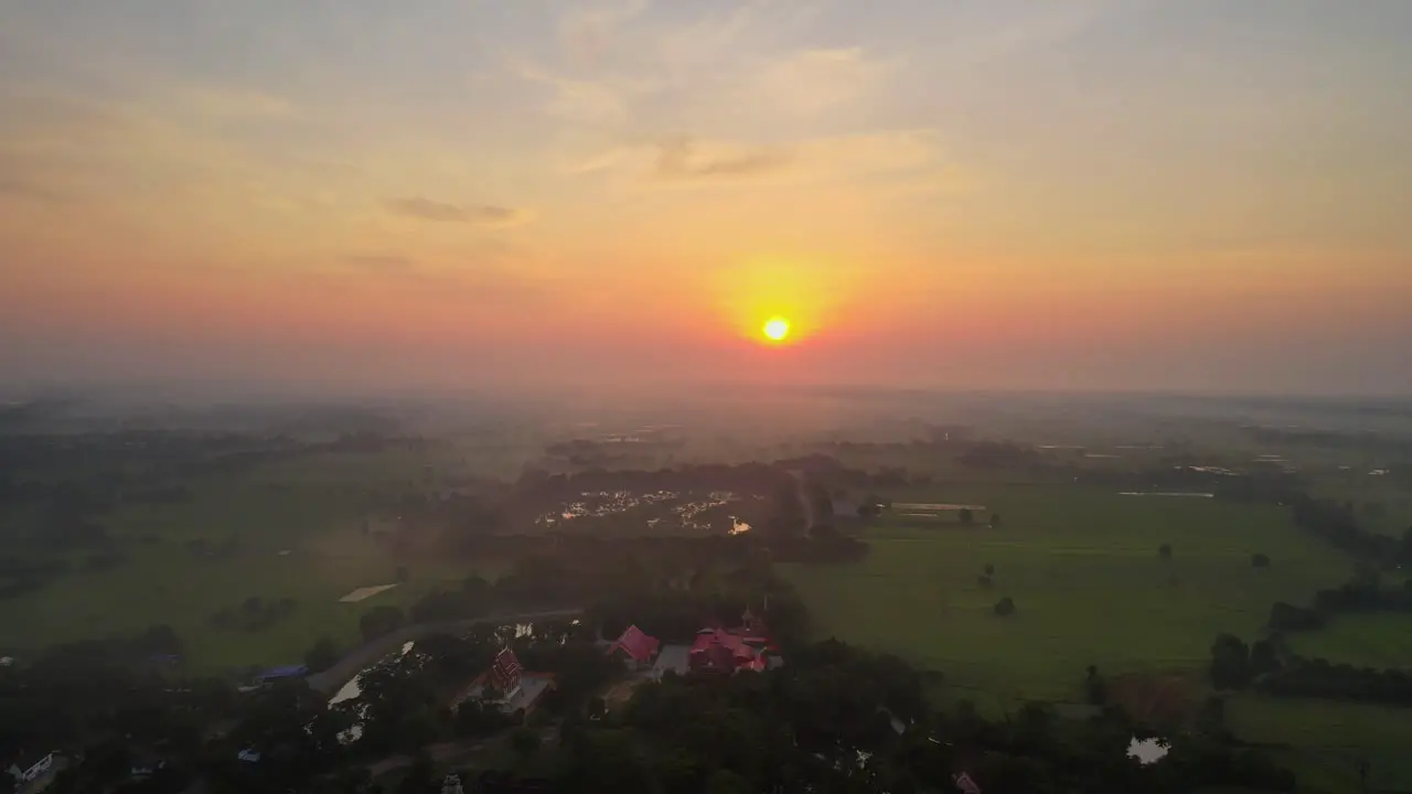 AERIAL drone footage of the sunrise over a swamp and rice field