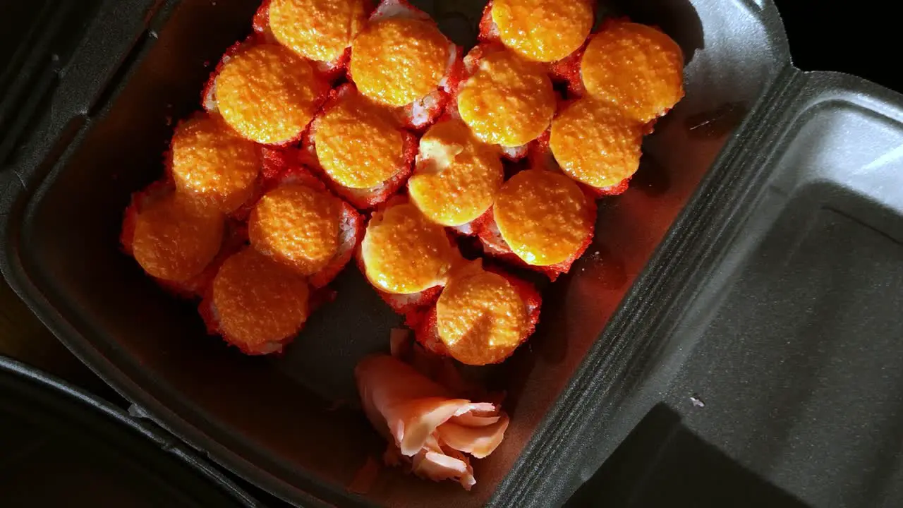 Rotating view looking down at takeaway sushi in a polystyrene box