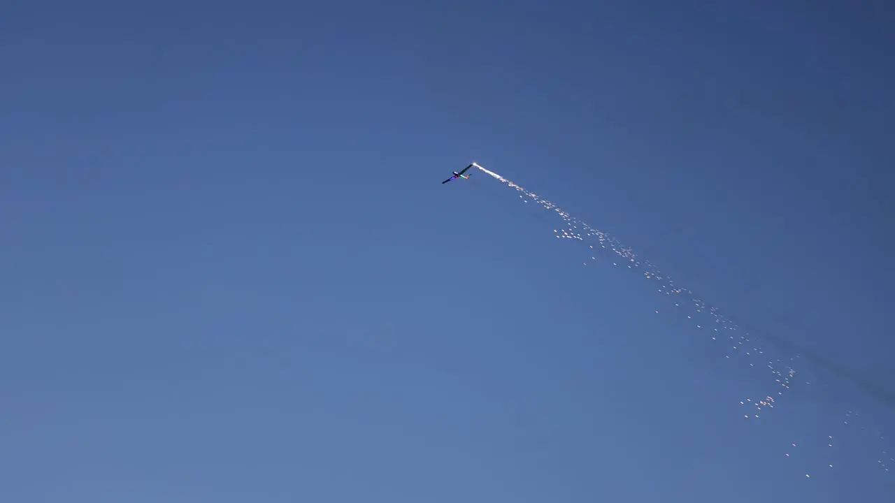 Pyrotechnical aircraft releasing fireworks from one wing during its display