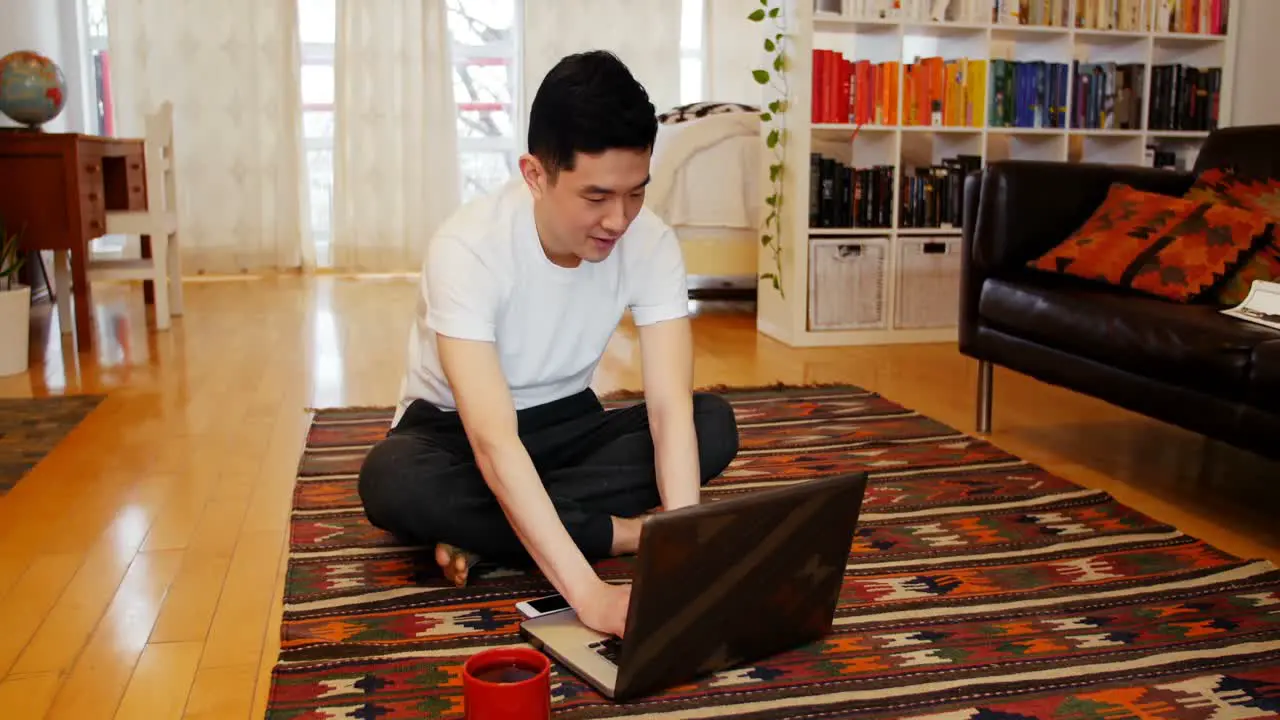 Man using laptop in living room