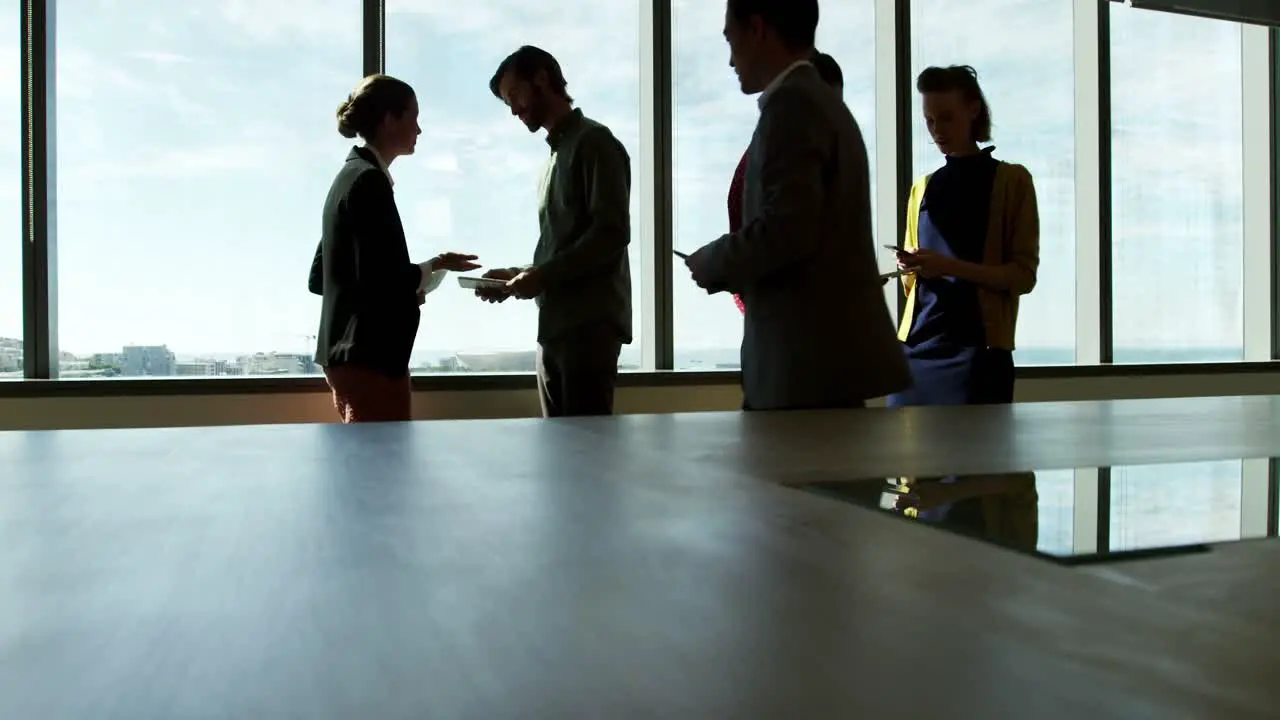 Business colleagues interacting with each other in conference room