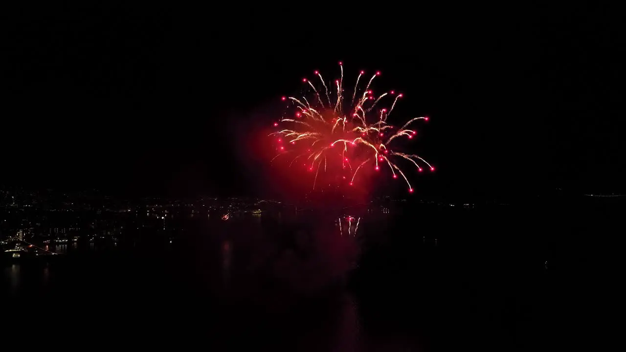 Amazing public fireworks from city of Bergen during new year celebration entering year of 2023 Aerial close to fireworks over byfjorden fjord