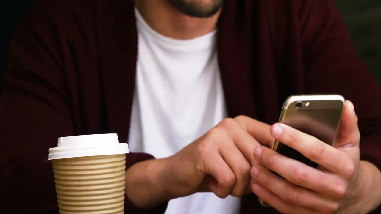 Man using mobile phone in cafÃ©