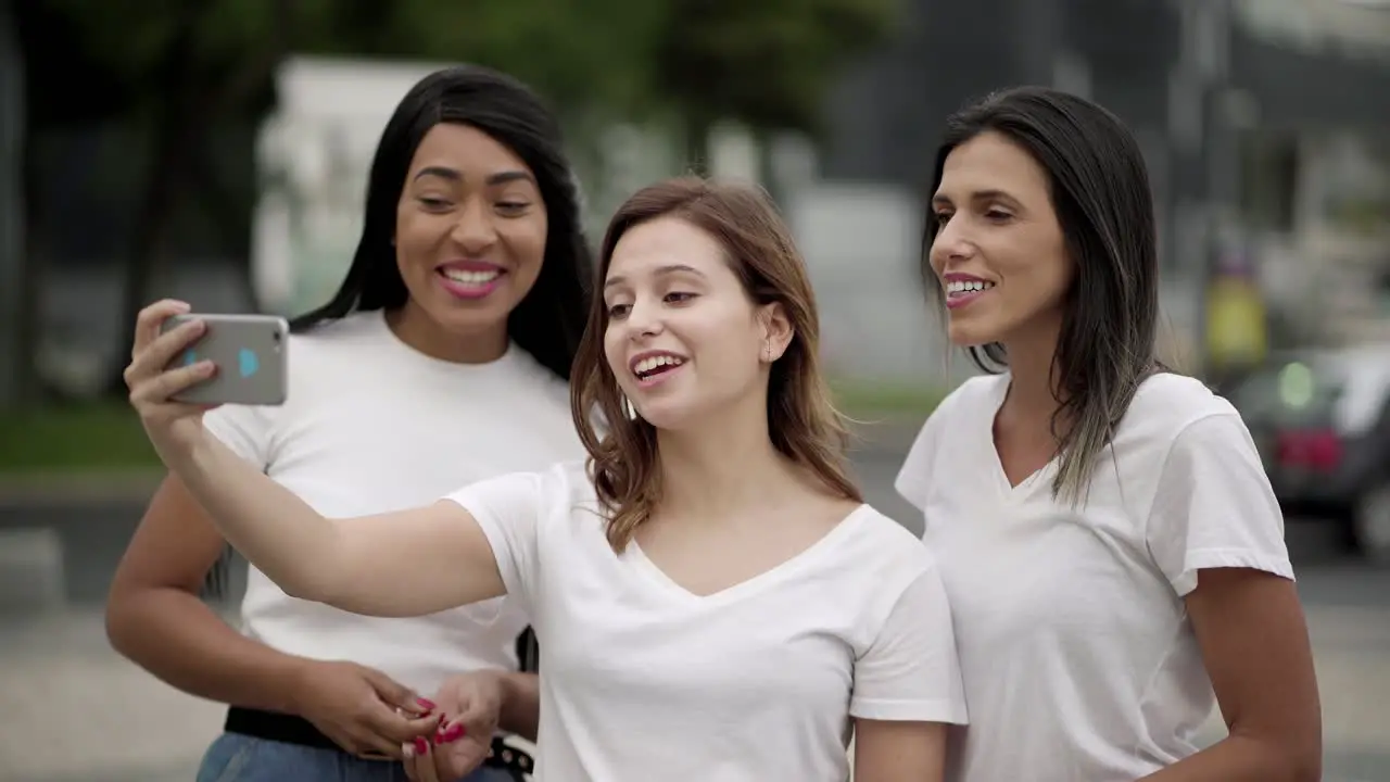 Smiling young women recording video message