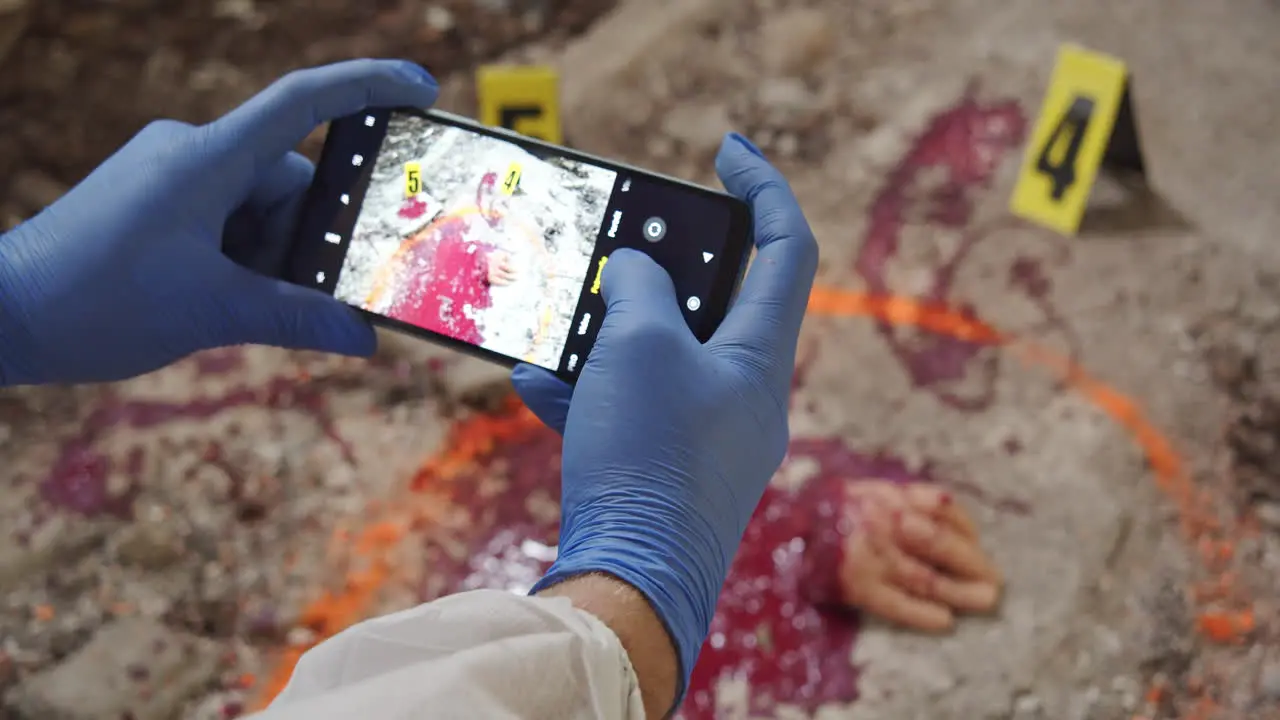 Forensic specialist takes a close-up of a gruesome crime scene