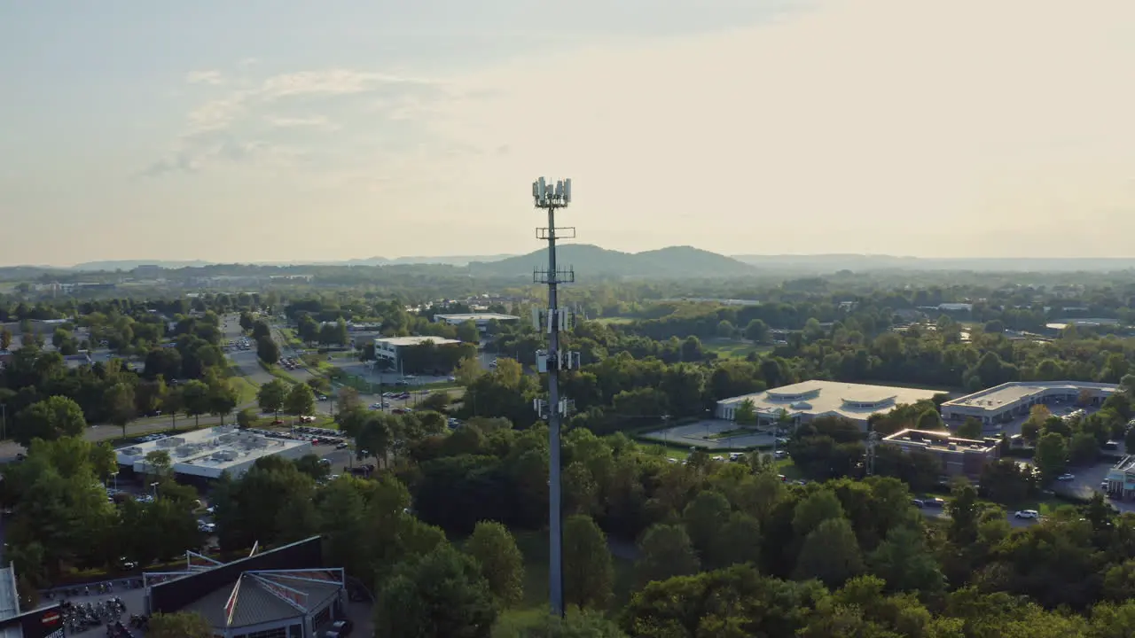 Aerial view orbiting around cell phone 5G radio communication tower 4K