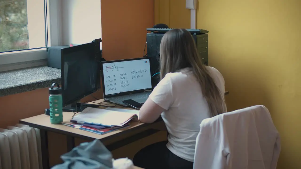 The teacher uses a computer for distance learning during covid quarantine