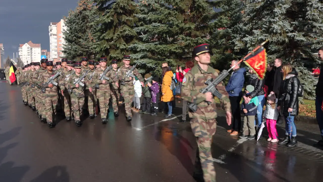 Armed members of military marching in parade through city of Miercurea Ciuc