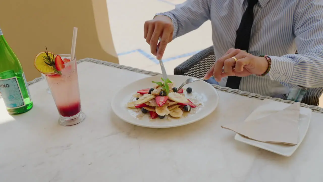 Enjoying while slicing his dessert