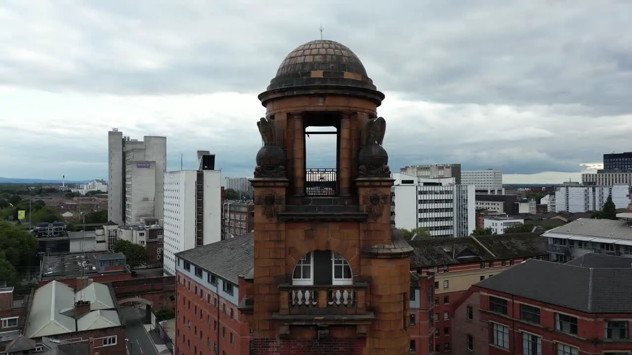 Aerial drone flight around London Road Fire Station in Manchester Piccadilly with Piccadilly Train Station in the background