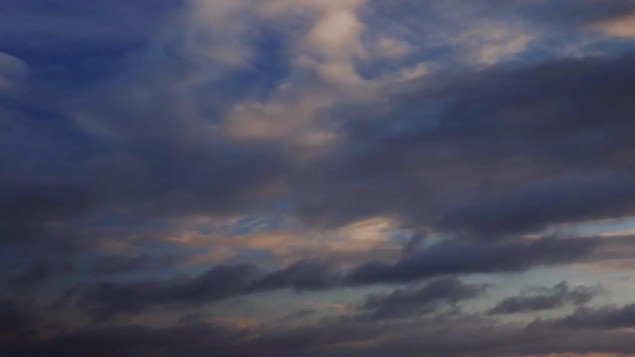 A time lapse shot with moving clouds showing a sunrise