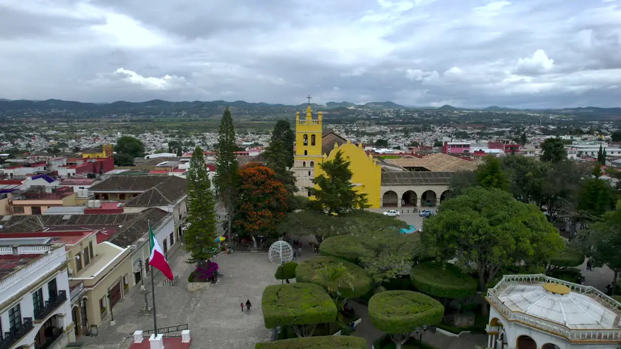 frontal drone shot of Comitan Chiapas Mexico main plaza during sunset