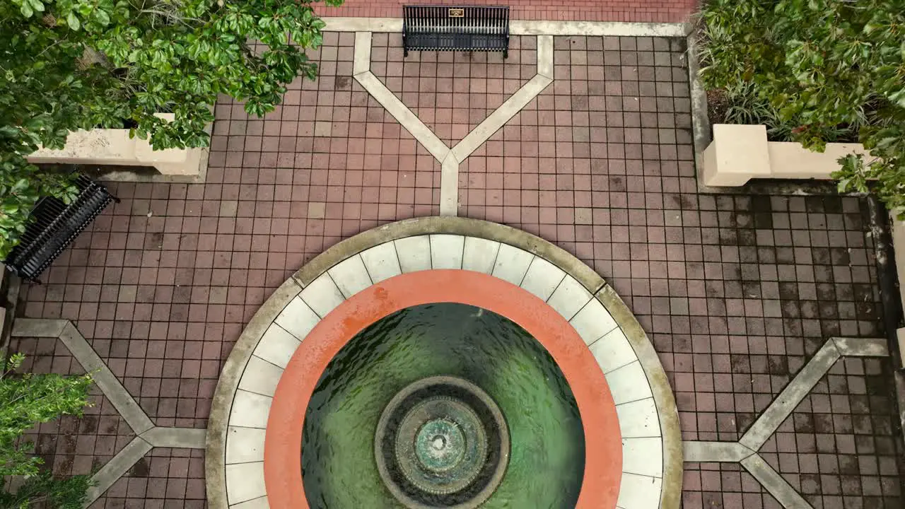 Aerial reverse reveal of a watch tower and park in Foley Alabama on a cloudy day