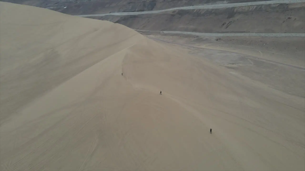 Tourist hiking the Dune of Iquique