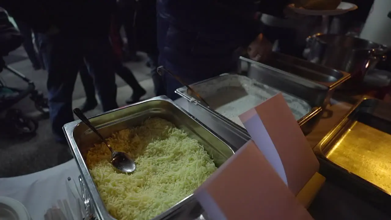 at an open air buffet a spoon is placed in a container with food