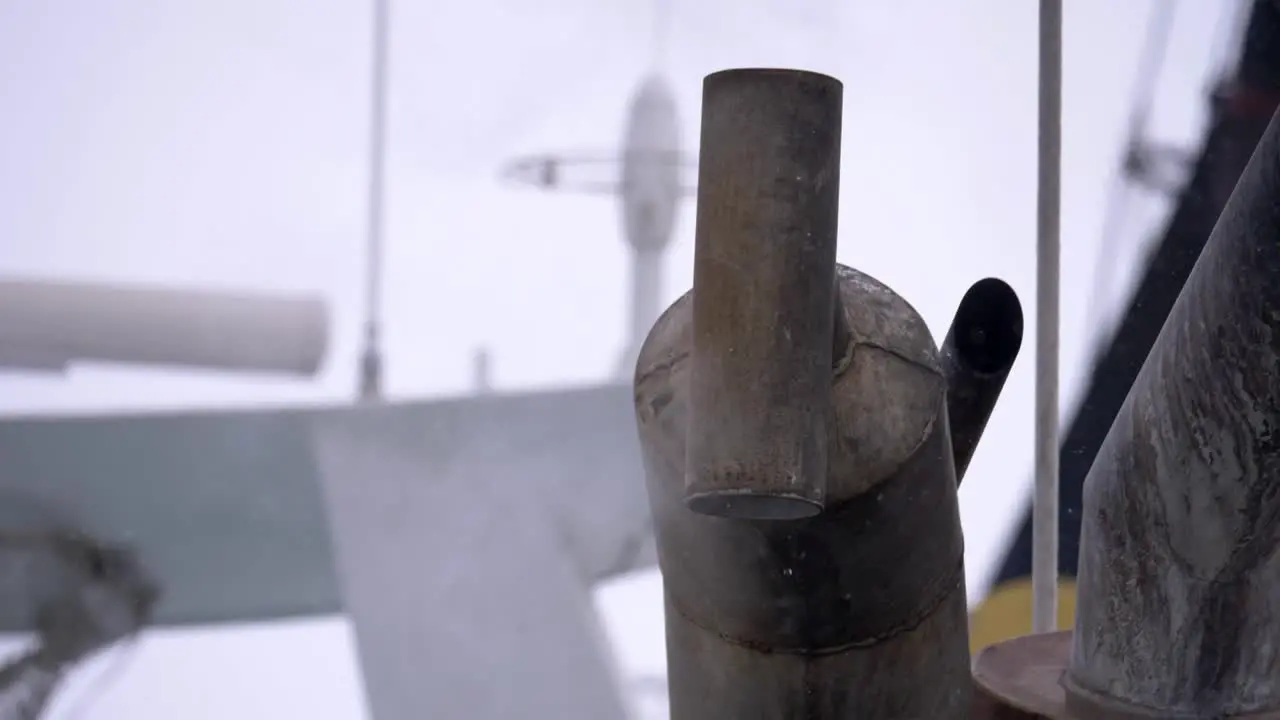 Slow motion dripping pipe on a boat beneath a cloudy sky