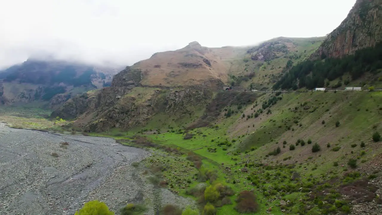 Drone flyover viewpoint Tergi valley Kazbegi mountain road pass Georgia