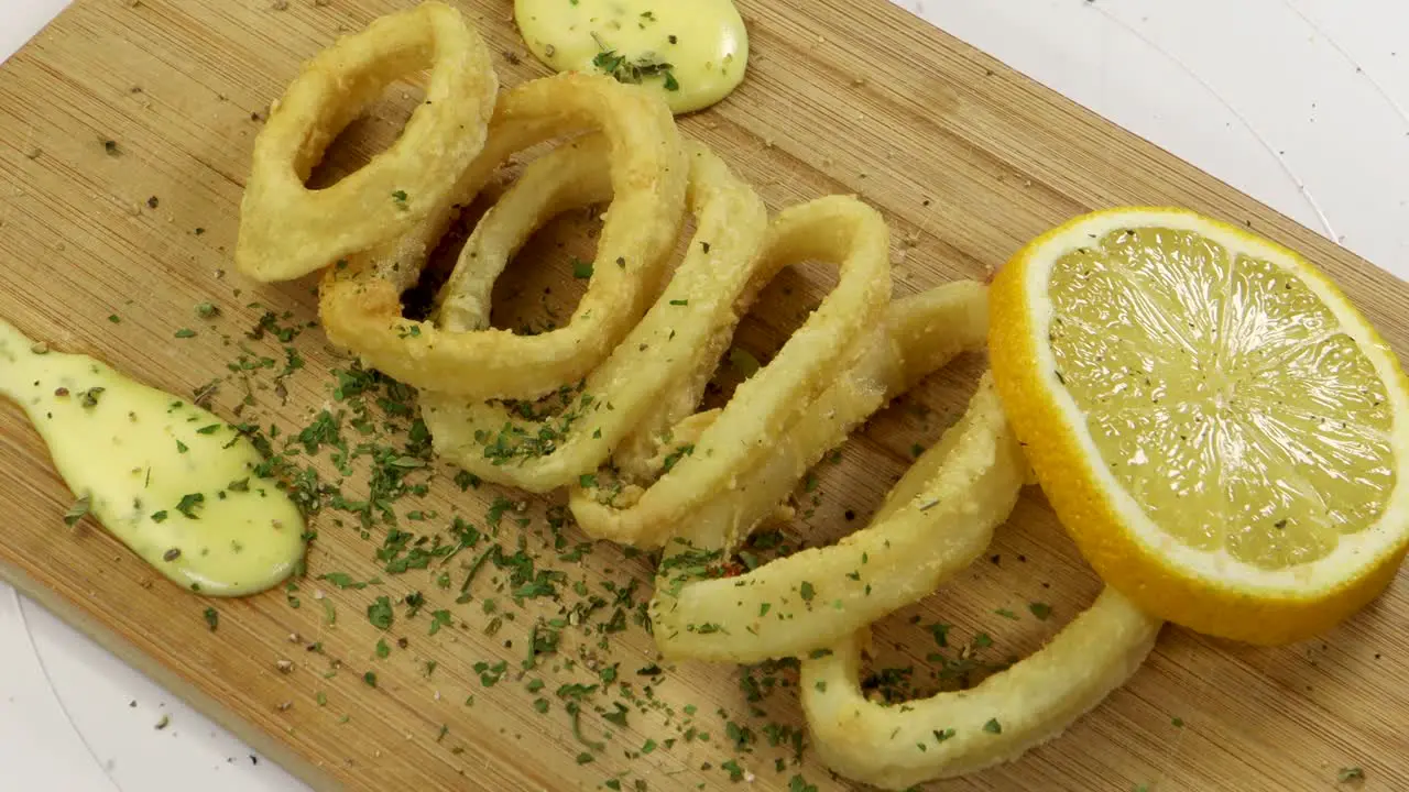 Adding pepper to fried squid rings