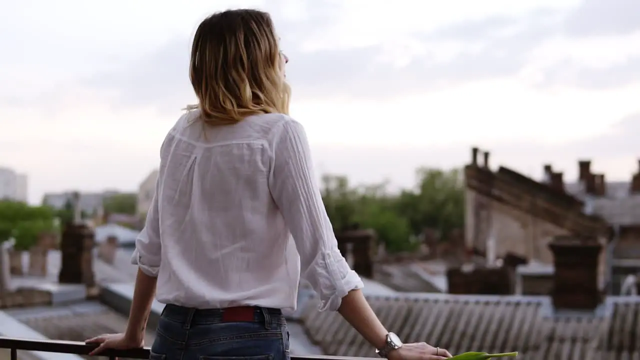 View From Behind Of Beautiful Woman Stands On The Balcony Or Terrace In Apartment At Day Time