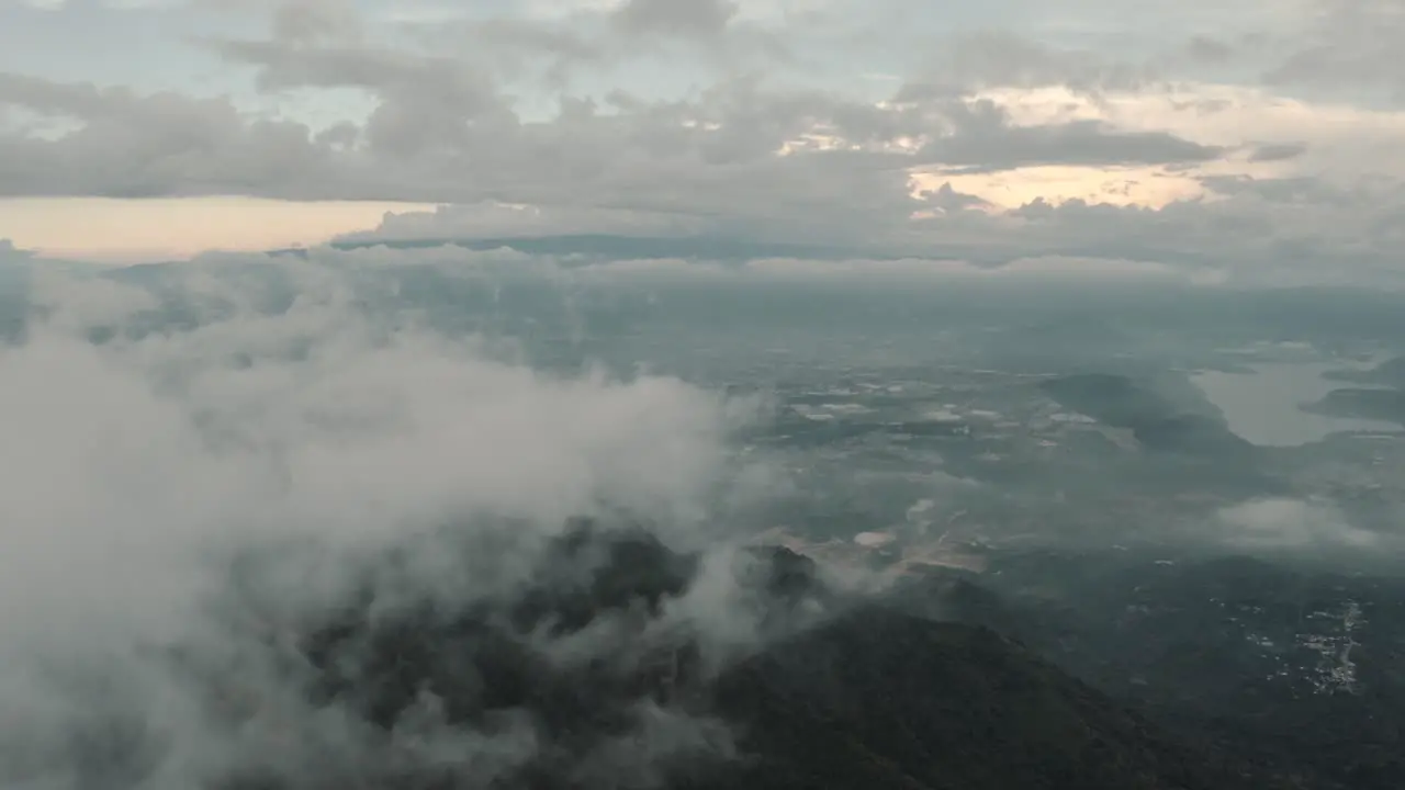 Drone aerial flying high over clouds landscape view of Guatemala lake Amatitlan