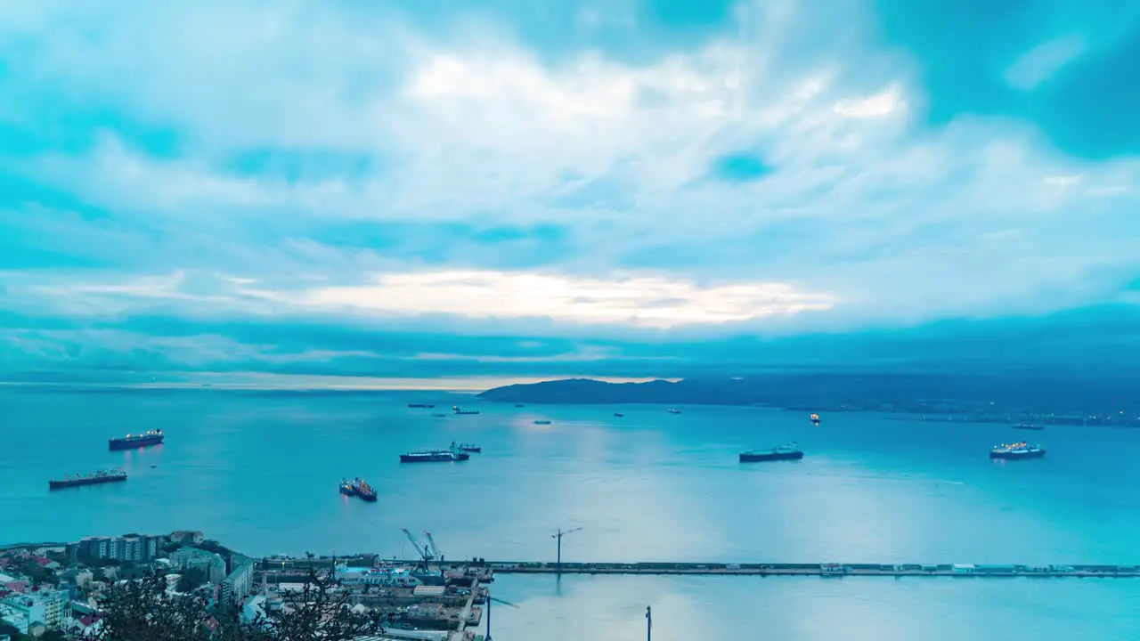 Harbor of Gibraltar with vessels and dark stormy sky time lapse view