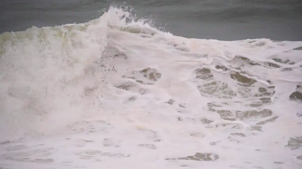 Slow motion waves with white foam in the middle of a storm in the ocean