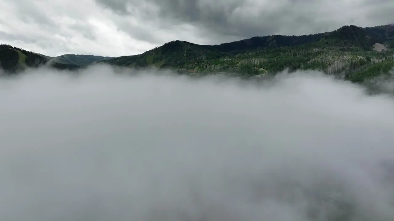 Aerial of low fog hanging over mountain and forest trees-3